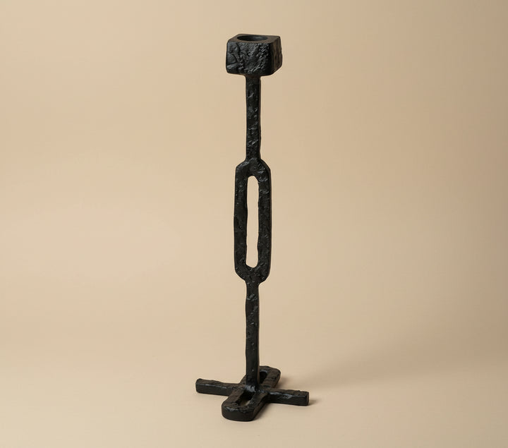 Black metal candle holder with 'Vanik Living' branding on a white background