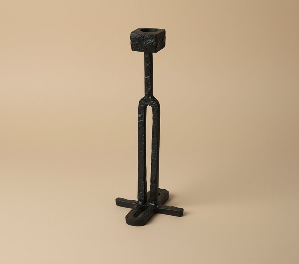 Black metal candle holder on a white background with 'vanik living' branding.