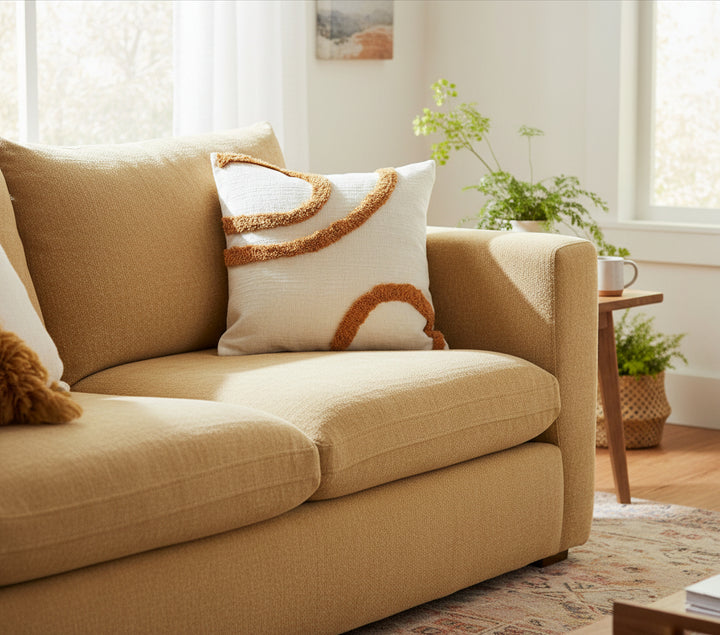 Decorative pillow with brown trim on a white background, featuring the brand 'Vanik Living'.
